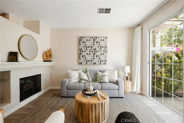 6375 Woodrow Ct Unit 3, Chino Hills, CA 91709 - living area featuring wood finished floors, baseboards, and a glass covered fireplace