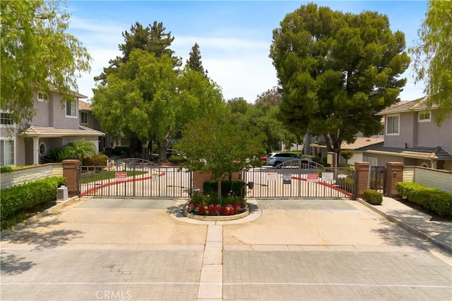 6375 Woodrow Ct Unit 3, Chino Hills, CA 91709 - view of concrete road with a gate, curbs, and a gated entry