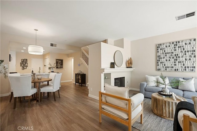 6375 Woodrow Ct Unit 3, Chino Hills, CA 91709 - living room featuring baseboards, wood finished floors, and stairway