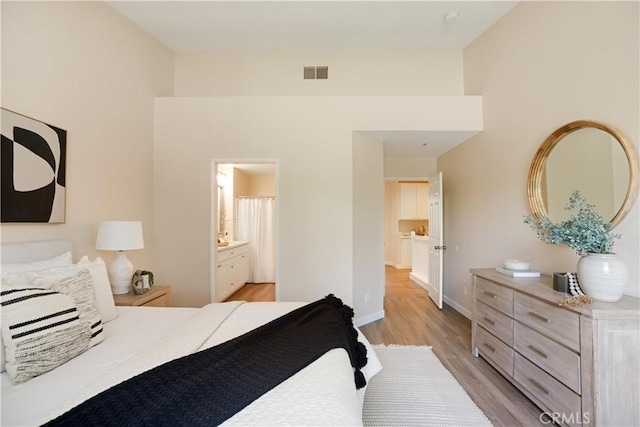 6375 Woodrow Ct Unit 3, Chino Hills, CA 91709 - bedroom with light wood-type flooring, baseboards, and ensuite bathroom