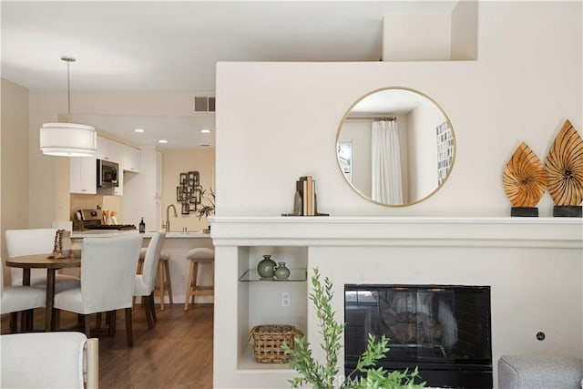 6375 Woodrow Ct Unit 3, Chino Hills, CA 91709 - living room with wood finished floors, recessed lighting, and a glass covered fireplace
