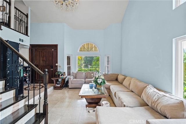 2350 Robert Rd, Rowland Heights, CA 91748 - living area with a towering ceiling, stairs, a chandelier, tile patterned flooring, and plenty of natural light