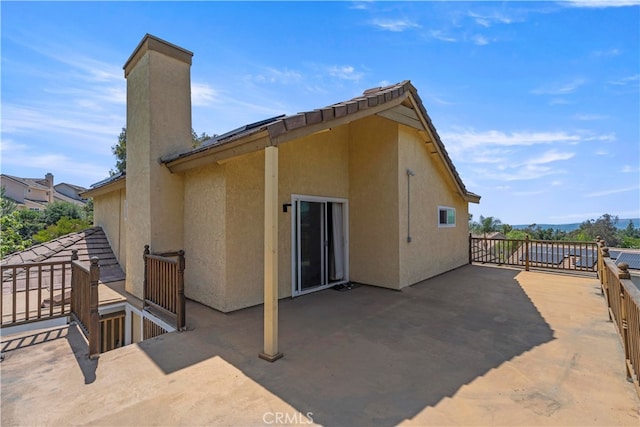 2350 Robert Rd, Rowland Heights, CA 91748 - rear view of house with stucco siding, a chimney, and a patio area
