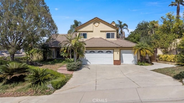 2350 Robert Rd, Rowland Heights, CA 91748 - traditional-style house with an attached garage, driveway, stucco siding, a chimney, and a tile roof