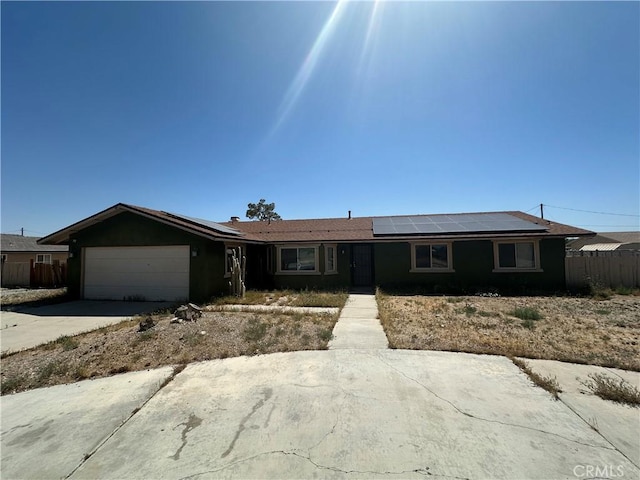 15395 Apache Rd, Apple Valley, CA 92307 - ranch-style home featuring a garage, roof mounted solar panels, and concrete driveway