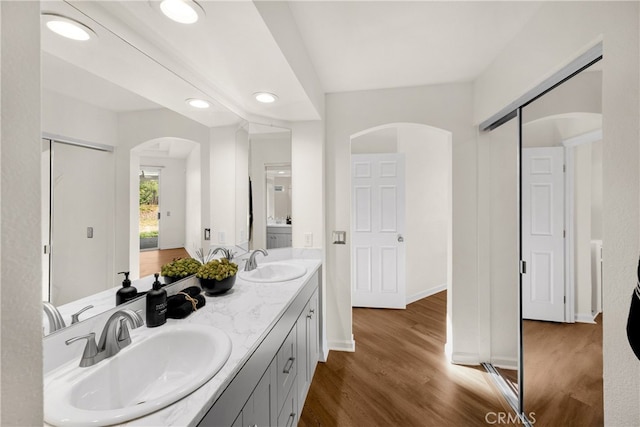 27472 Swallow Ct, Temecula, CA 92591 - bathroom featuring wood finished floors, double vanity, and recessed lighting