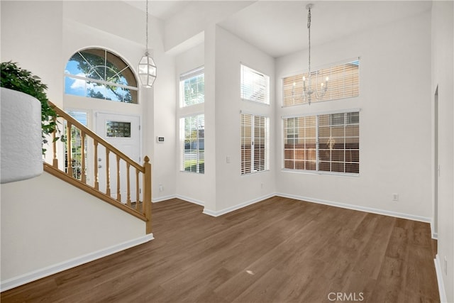 27472 Swallow Ct, Temecula, CA 92591 - entrance foyer featuring a chandelier, a towering ceiling, wood finished floors, and stairway