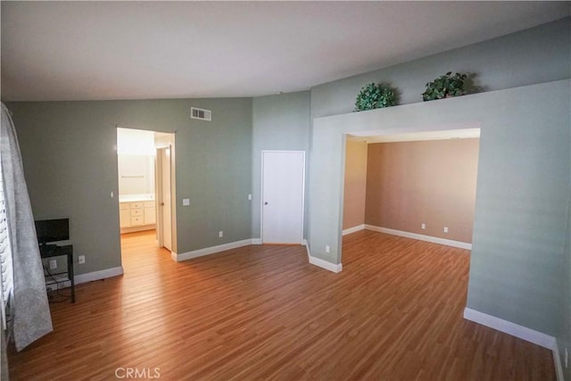 14194 De Sota Dr, Victorville, CA 92392 - unfurnished room with wood finished floors, lofted ceiling, and baseboards