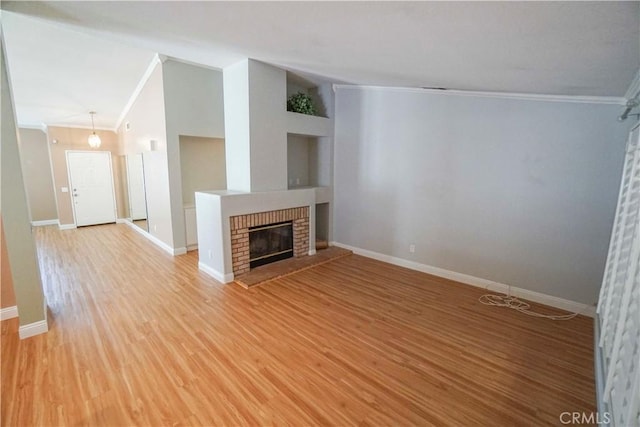 14194 De Sota Dr, Victorville, CA 92392 - unfurnished living room with crown molding, baseboards, light wood-style floors, a brick fireplace, and built in shelves
