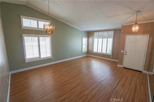 14194 De Sota Dr, Victorville, CA 92392 - entryway with a chandelier, wood finished floors, baseboards, lofted ceiling, and ornamental molding