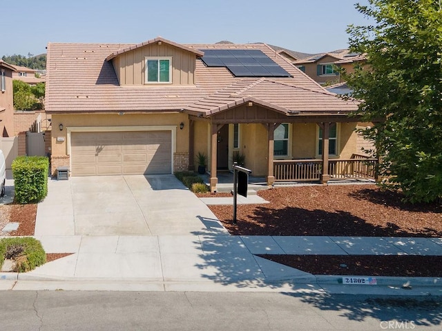 24802 Sandy Trail Pl, Menifee, CA 92584 - view of front of property featuring board and batten siding, a porch, solar panels, concrete driveway, and a garage