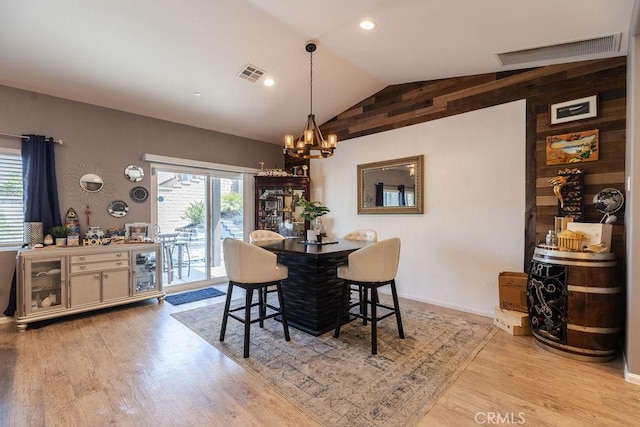 24802 Sandy Trail Pl, Menifee, CA 92584 - dining space featuring vaulted ceiling, wood finished floors, a chandelier, and wood walls