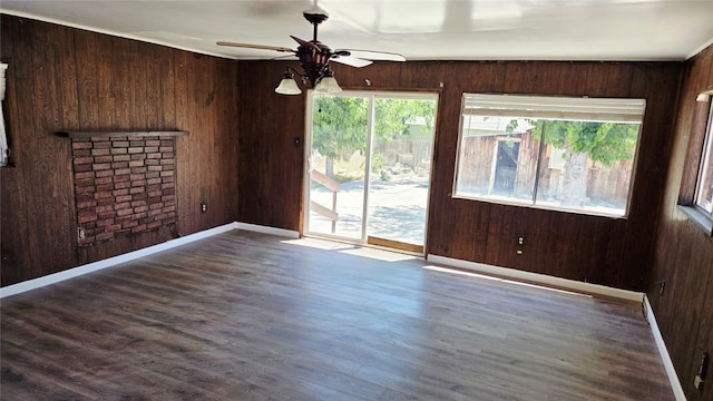 322 S 8th St, Taft, CA 93268 - empty room with a ceiling fan, wood walls, a fireplace, and wood finished floors