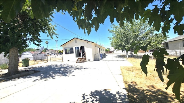 322 S 8th St, Taft, CA 93268 - rear view of house with entry steps and stucco siding