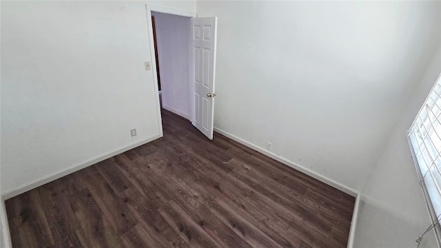 322 S 8th St, Taft, CA 93268 - unfurnished room with baseboards and dark wood-style flooring