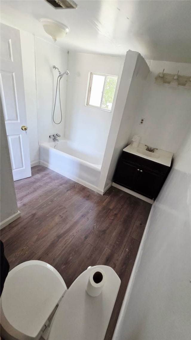 322 S 8th St, Taft, CA 93268 - bathroom featuring shower / washtub combination and wood finished floors
