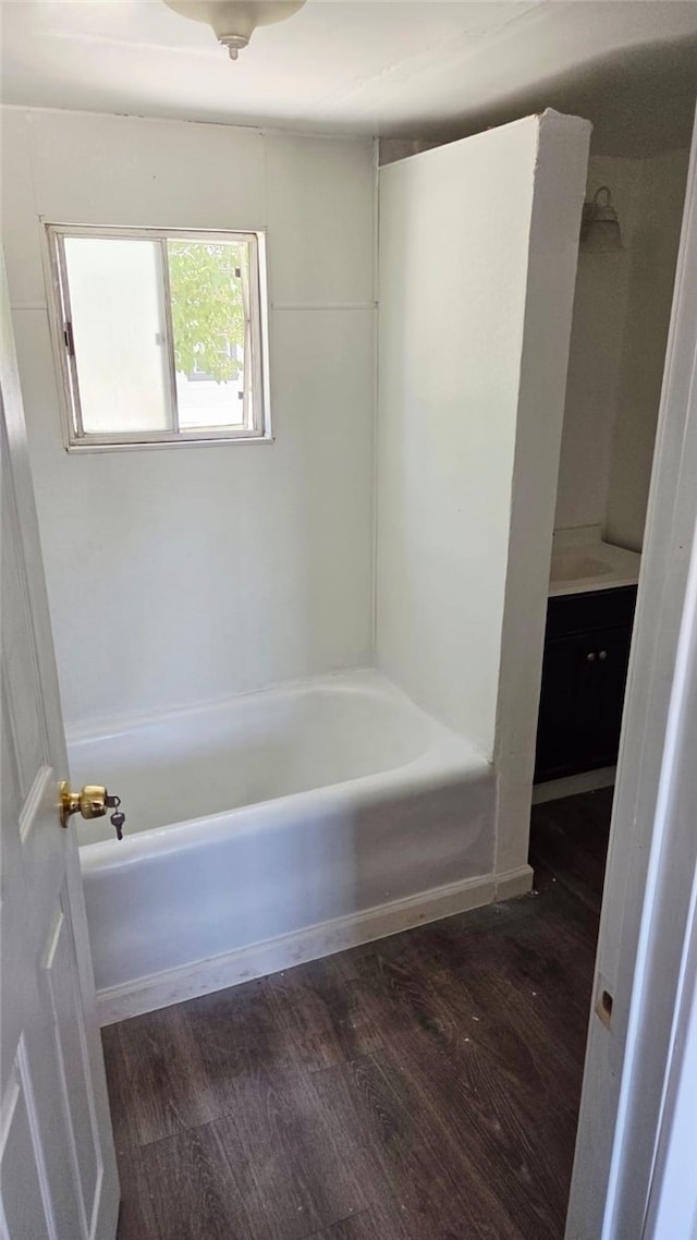 322 S 8th St, Taft, CA 93268 - bathroom featuring wood finished floors, a tub to relax in, and vanity