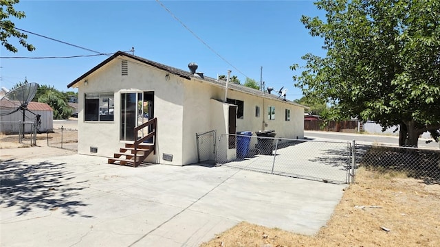322 S 8th St, Taft, CA 93268 - rear view of house featuring entry steps, a gate, stucco siding, and a patio area