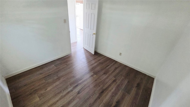 322 S 8th St, Taft, CA 93268 - empty room with dark wood-style flooring and baseboards