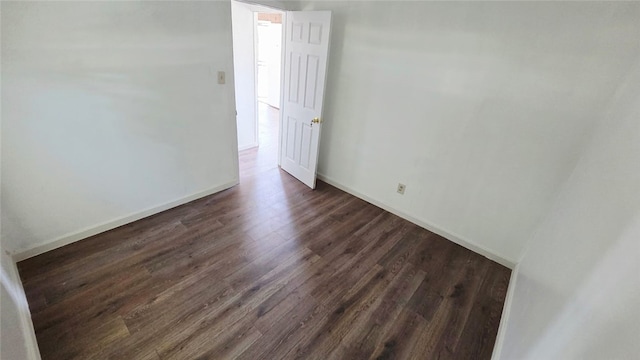 322 S 8th St, Taft, CA 93268 - empty room with dark wood finished floors and baseboards