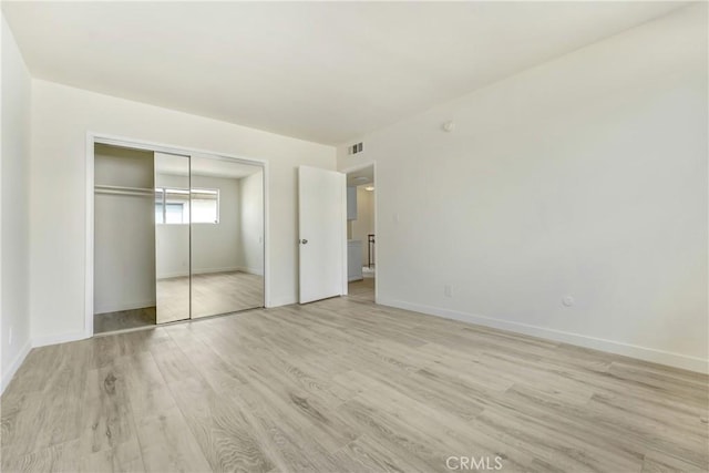 20235 Cohasset St Unit 6, Winnetka, CA 91306 - unfurnished bedroom featuring light wood-style flooring, baseboards, and a closet