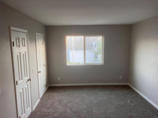 25675 Via Del Rey, San Juan Capistrano, CA 92675 - unfurnished bedroom featuring dark colored carpet, baseboards, and two closets