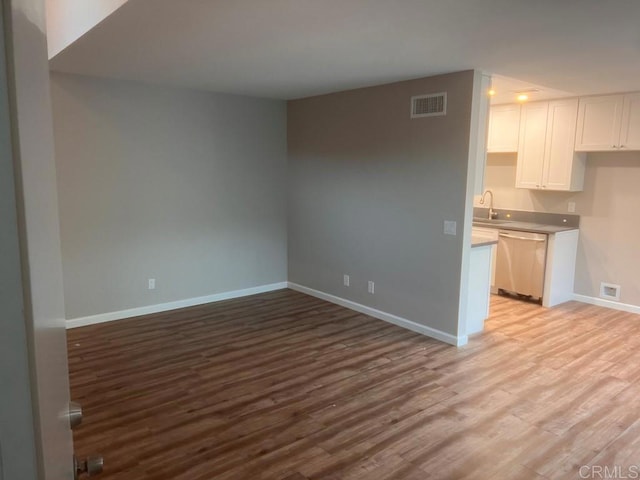 25675 Via Del Rey, San Juan Capistrano, CA 92675 - unfurnished living room featuring baseboards, light wood-style floors, and a sink