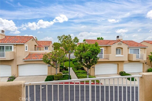 2444 Paseo Circulo, Tustin, CA 92782 - view of front of property featuring a tiled roof, a garage, a chimney, and stucco siding