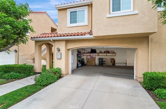 2444 Paseo Circulo, Tustin, CA 92782 - view of front of home featuring a garage, stucco siding, driveway, and a tile roof