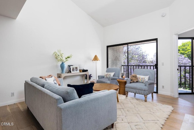 4210 Via Arbolada Unit 308, Los Angeles, CA 90042 - living area featuring high vaulted ceiling, wood finished floors, and baseboards