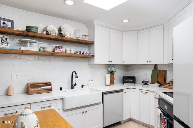 4210 Via Arbolada Unit 308, Los Angeles, CA 90042 - kitchen with a sink, black oven, stainless steel dishwasher, light countertops, and white cabinetry
