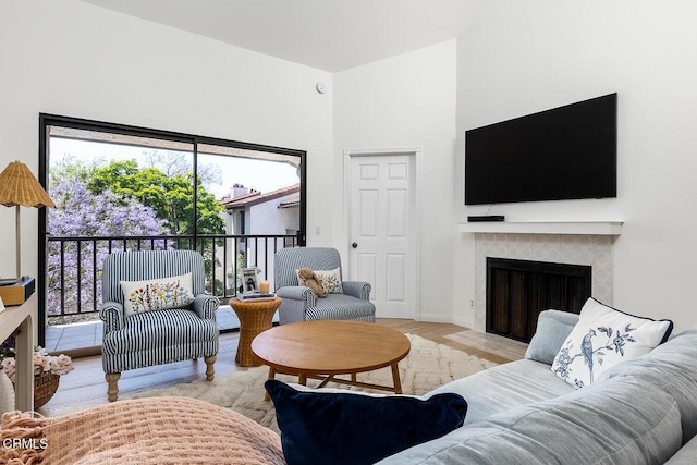 4210 Via Arbolada Unit 308, Los Angeles, CA 90042 - living area featuring a tile fireplace, wood finished floors, and baseboards