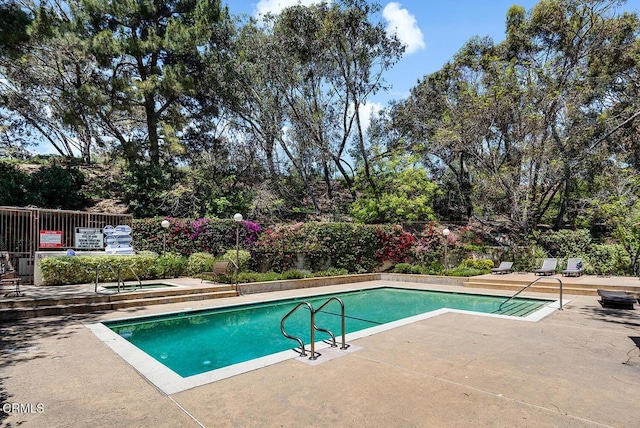4210 Via Arbolada Unit 308, Los Angeles, CA 90042 - view of swimming pool with a patio area, a hot tub, and view of wooded area
