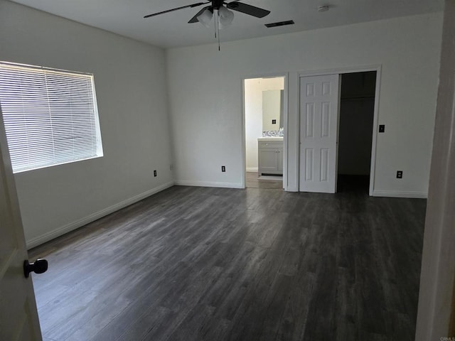 704 S H St, Imperial, CA 92251 - unfurnished bedroom with dark wood-type flooring, baseboards, and ensuite bathroom