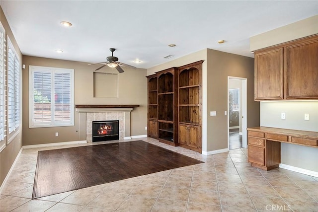 39766 Pinedale Way, Murrieta, CA 92562 - unfurnished living room with a ceiling fan, a fireplace, light tile patterned floors, recessed lighting, and built in study area