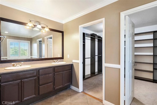 39766 Pinedale Way, Murrieta, CA 92562 - bathroom featuring double vanity, a walk in closet, tile patterned flooring, and crown molding