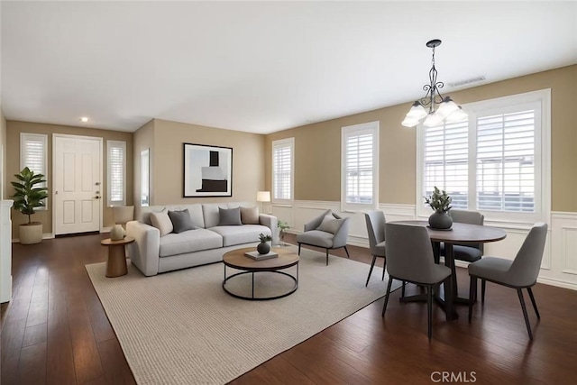 39766 Pinedale Way, Murrieta, CA 92562 - living room featuring wainscoting, a chandelier, dark wood-style floors, a decorative wall, and recessed lighting