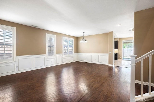 39766 Pinedale Way, Murrieta, CA 92562 - unfurnished room featuring a chandelier, wood-type flooring, wainscoting, and a decorative wall
