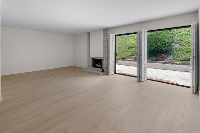 22 Seaview Dr S, Rolling Hills Estates, CA 90274 - unfurnished living room with light wood-type flooring and a fireplace