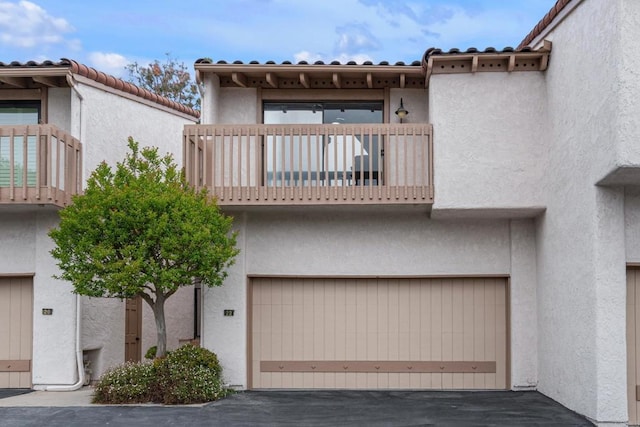 22 Seaview Dr S, Rolling Hills Estates, CA 90274 - view of front of house with a balcony, a garage, stucco siding, and a tiled roof