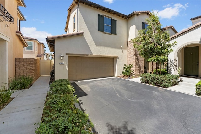 2851 Menorca Cir, Corona, CA 92881 - view of front facade with an attached garage, stucco siding, asphalt driveway, and a tile roof