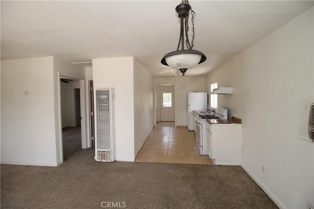 509 E Williams St, Yermo, CA 92398 - kitchen with a heating unit, white gas stove, under cabinet range hood, light carpet, and baseboards