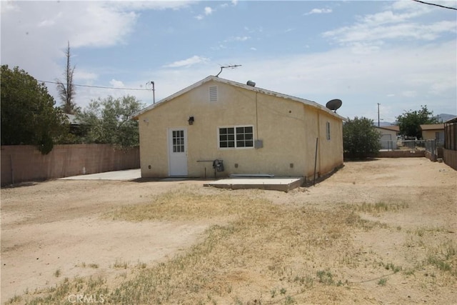 509 E Williams St, Yermo, CA 92398 - rear view of property with a fenced backyard and stucco siding