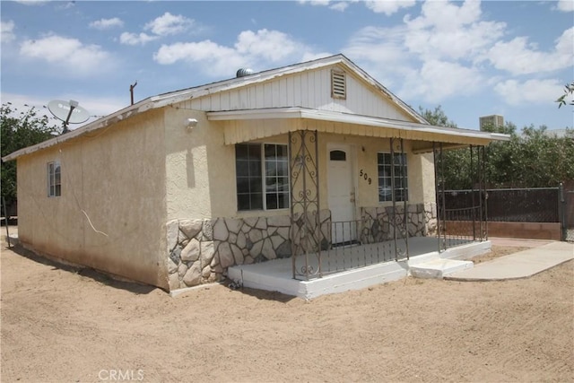 509 E Williams St, Yermo, CA 92398 - bungalow-style home with a porch, stone siding, and stucco siding