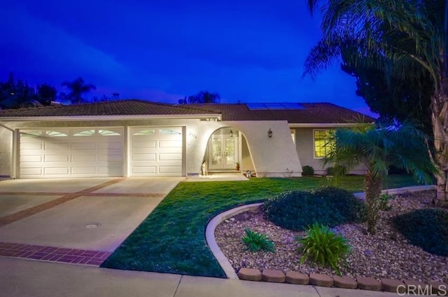 2528 Windmill View Rd, El Cajon, CA 92020 - view of front of home featuring concrete driveway, stucco siding, a garage, solar panels, and french doors