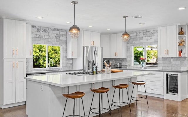 2528 Windmill View Rd, El Cajon, CA 92020 - kitchen with appliances with stainless steel finishes, a sink, wine cooler, open shelves, and white cabinets