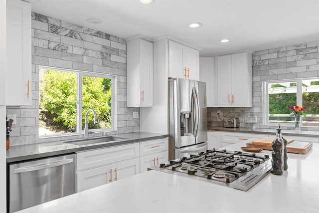 2528 Windmill View Rd, El Cajon, CA 92020 - kitchen with appliances with stainless steel finishes, a sink, backsplash, healthy amount of natural light, and recessed lighting