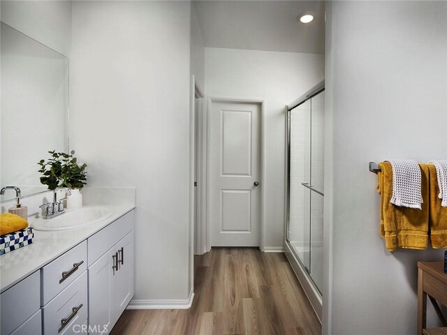 35390 Garcia St, Beaumont, CA 92223 - full bath with vanity, wood finished floors, a shower stall, baseboards, and recessed lighting