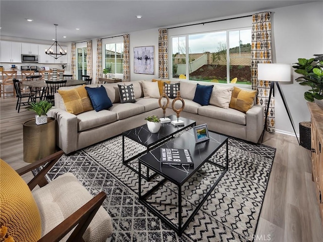 35390 Garcia St, Beaumont, CA 92223 - living room with wood finished floors, recessed lighting, and a chandelier