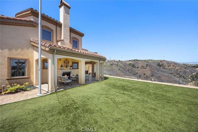 21925 Heatheridge Dr, Yorba Linda, CA 92887 - rear view of property with a tile roof, a chimney, a patio, stucco siding, and an outdoor living space